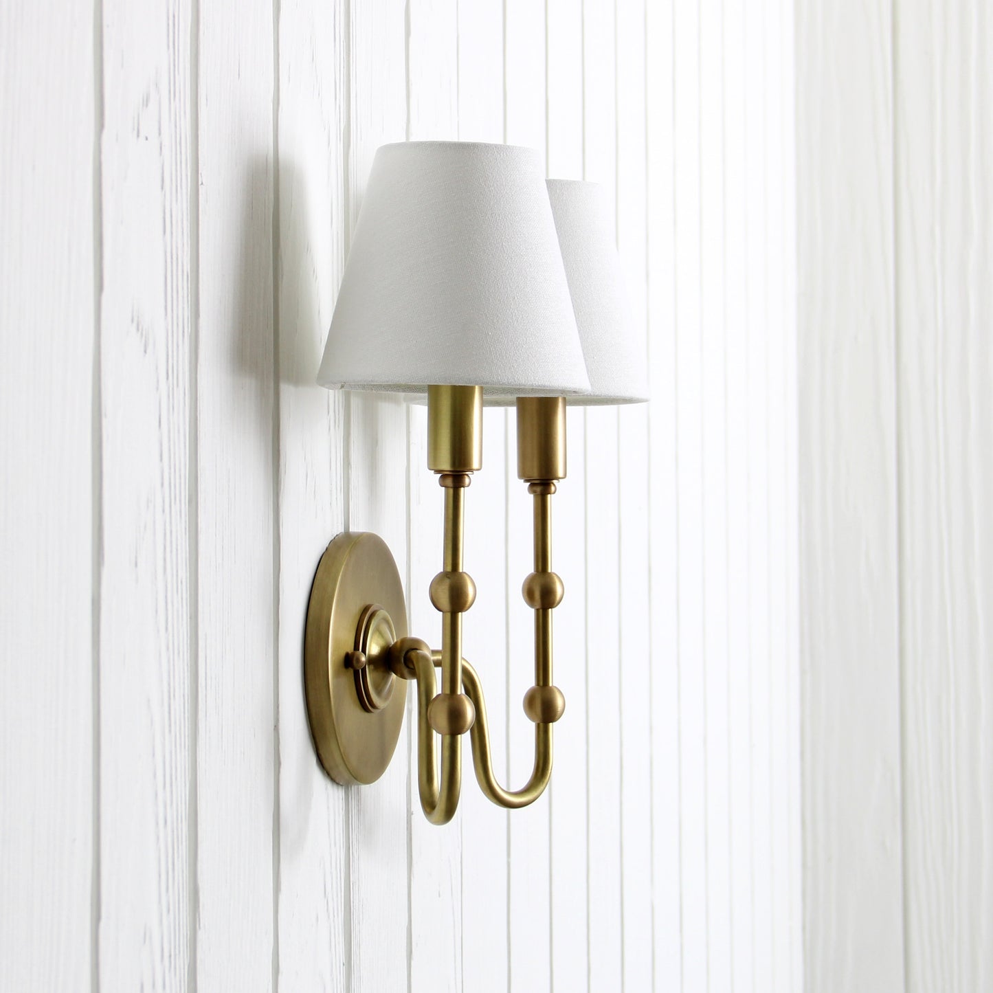 Oyère Dual Wall Sconce in Heritage Brass