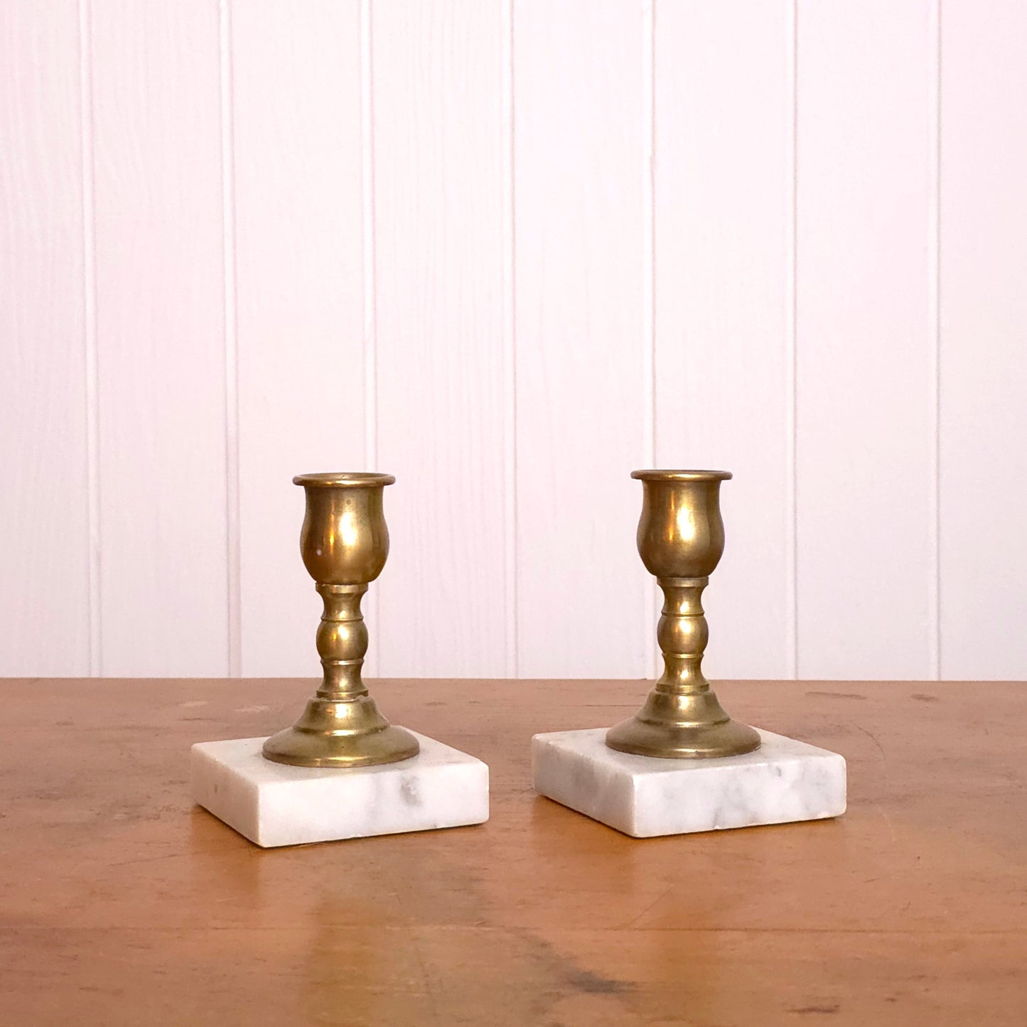Pair of solid brass candleholders with marble bases