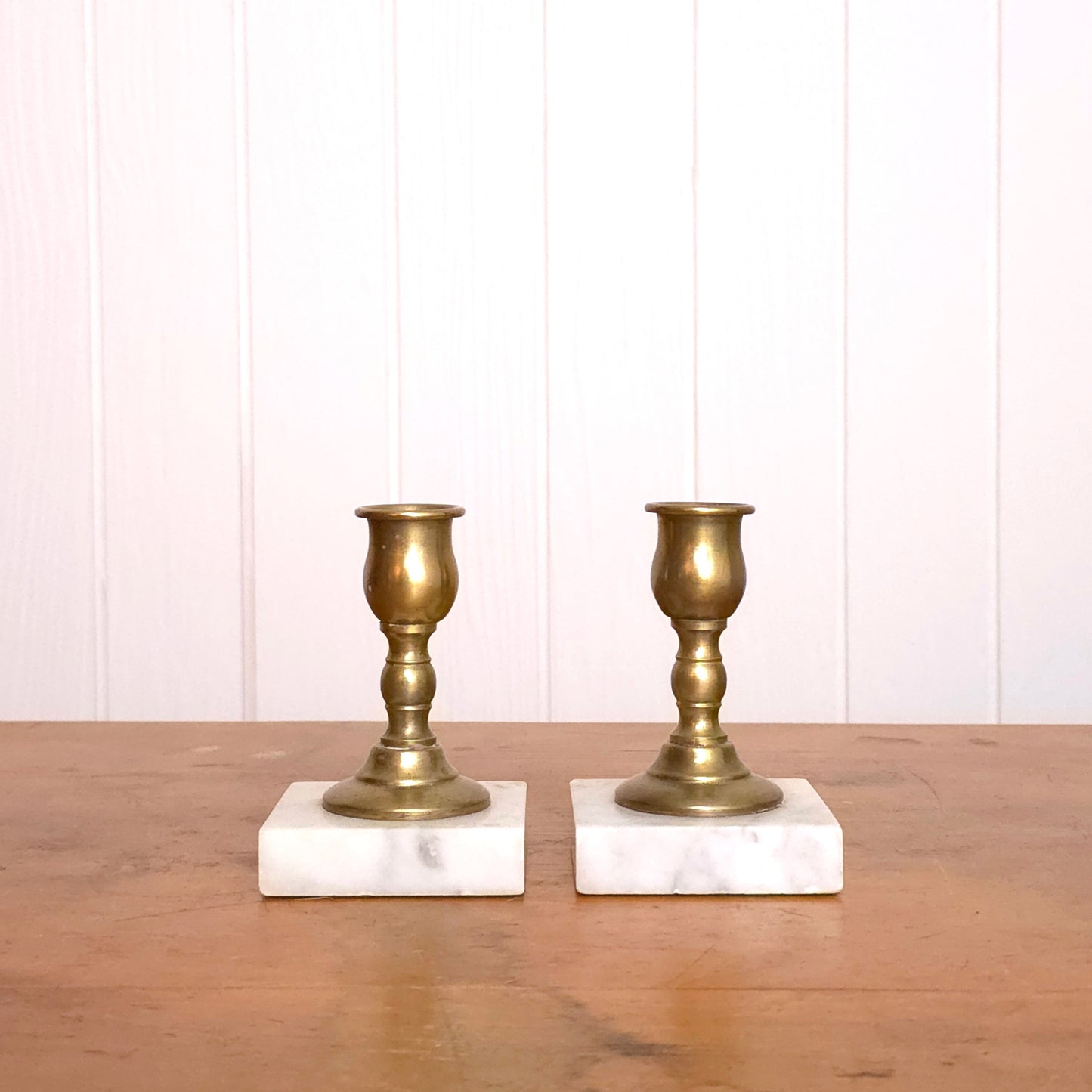 Pair of solid brass candleholders with marble bases