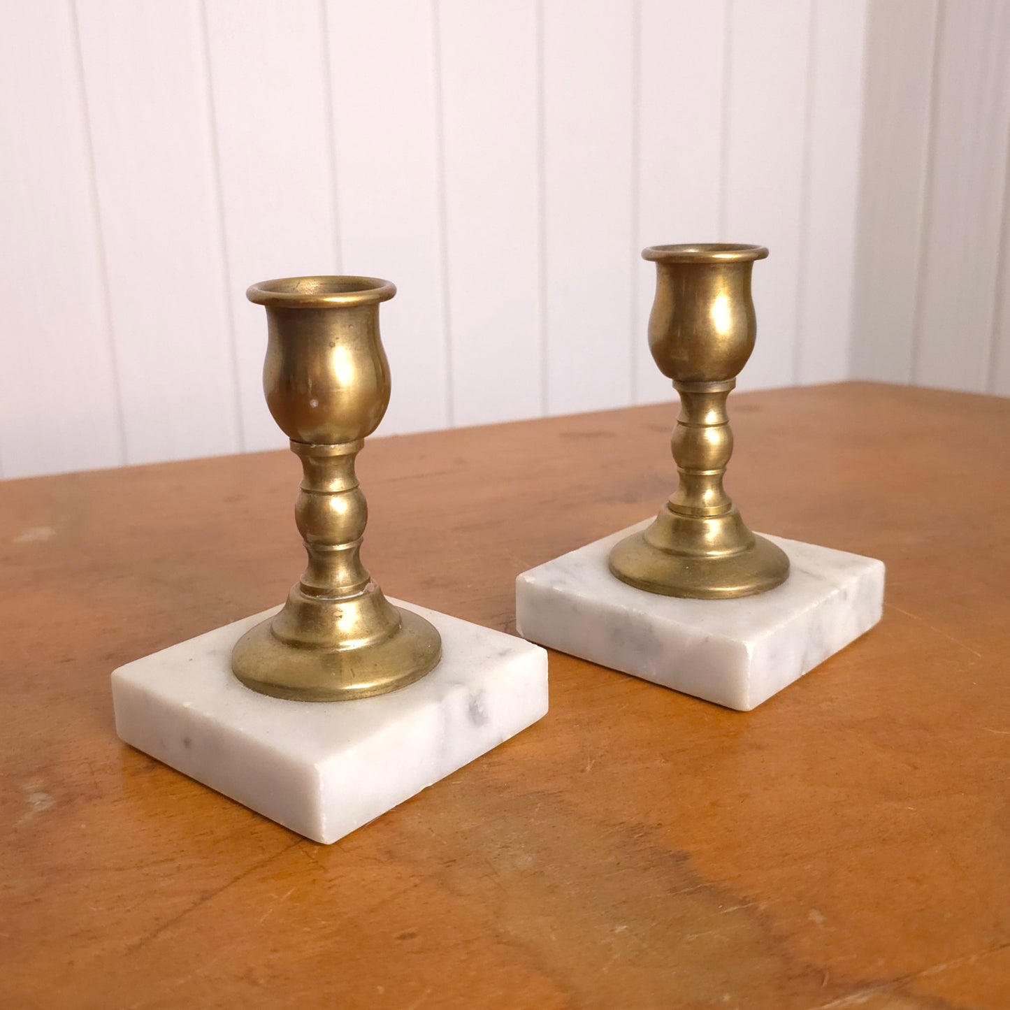 Pair of solid brass candleholders with marble bases