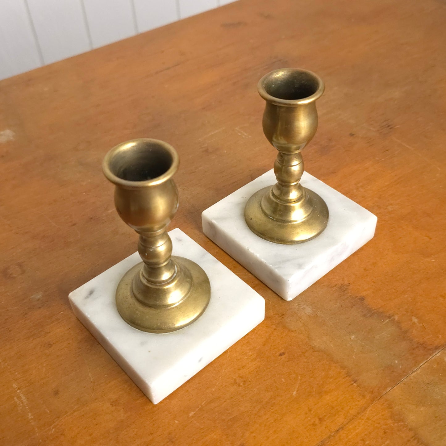 Pair of solid brass candleholders with marble bases