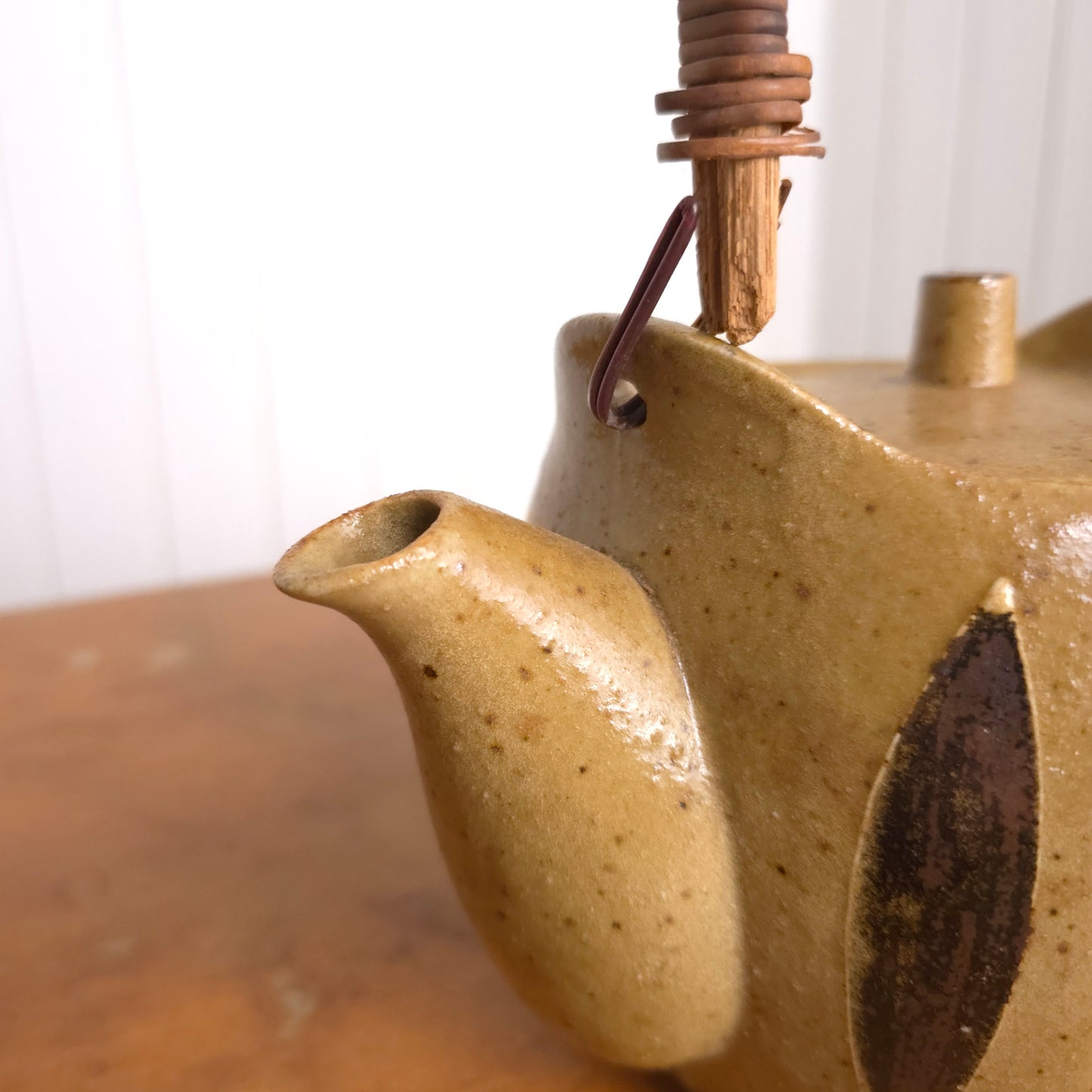 Spout detail of vintage Japanese reed handle earthenware teapot