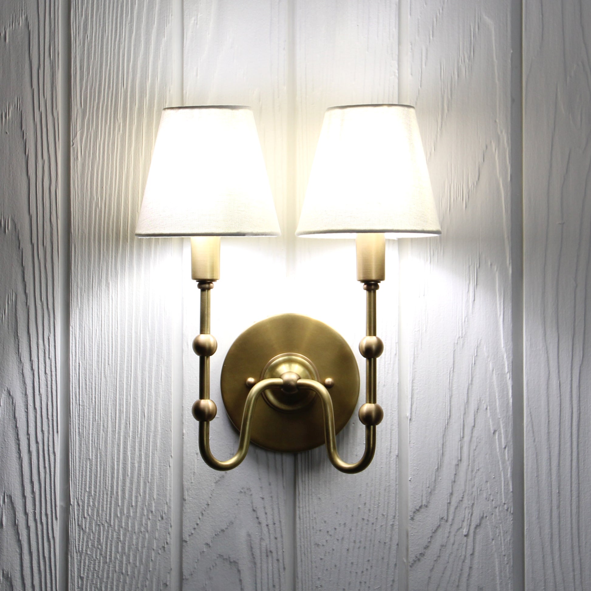 Oyère Dual Wall Sconce in Heritage Brass