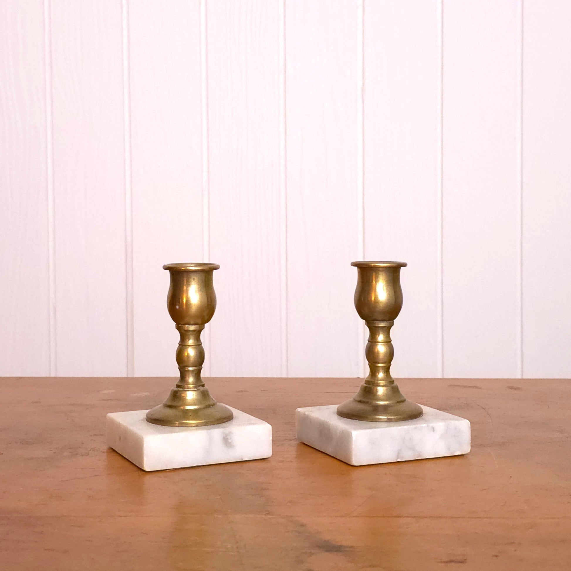 Pair of solid brass candleholders with marble bases