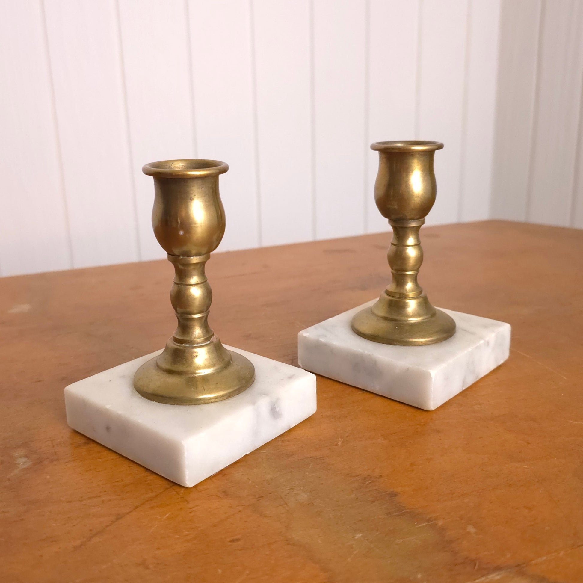 Pair of solid brass candleholders with marble bases