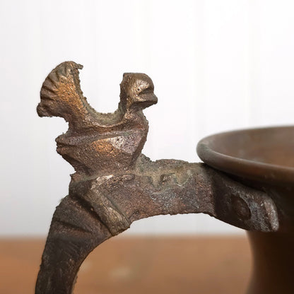 Detail of copper pitcher with brutalist bird handle