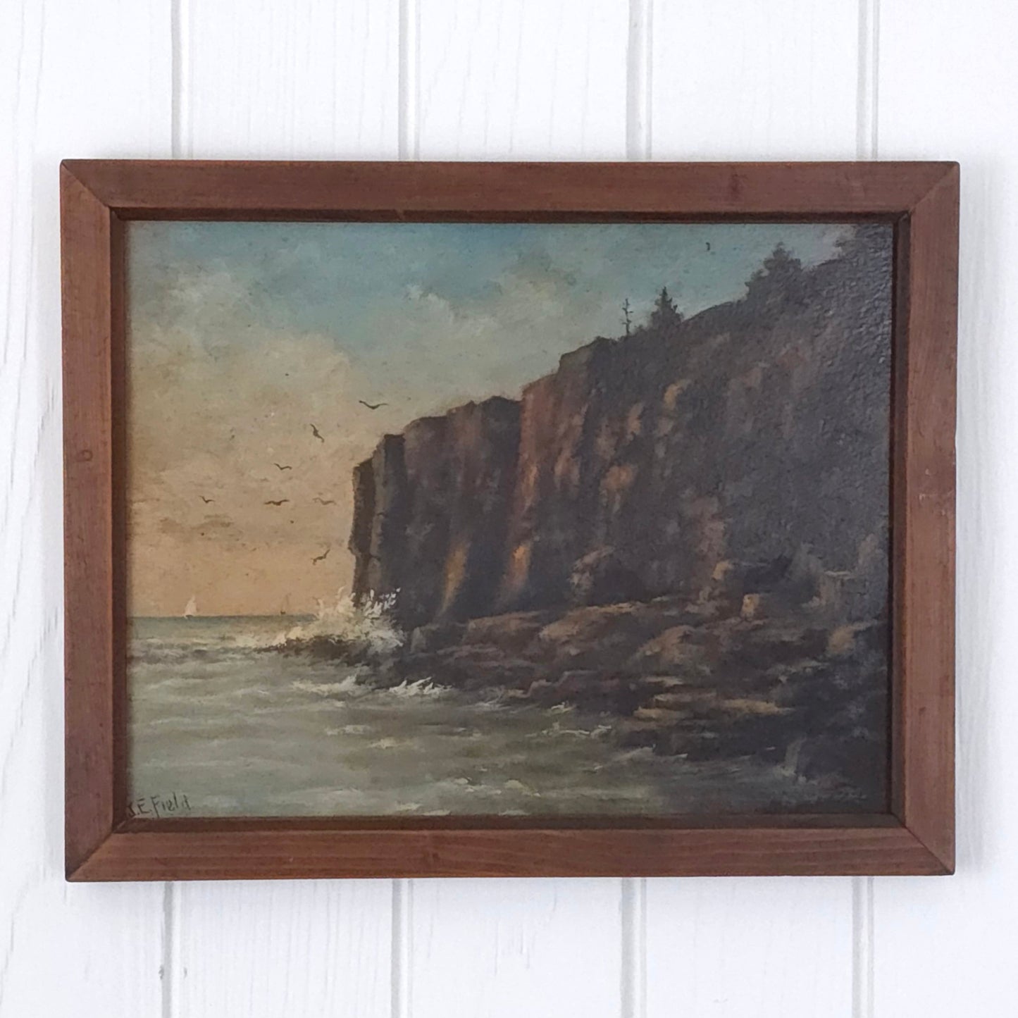 Vintage seaside cliff painting by J.E. Field