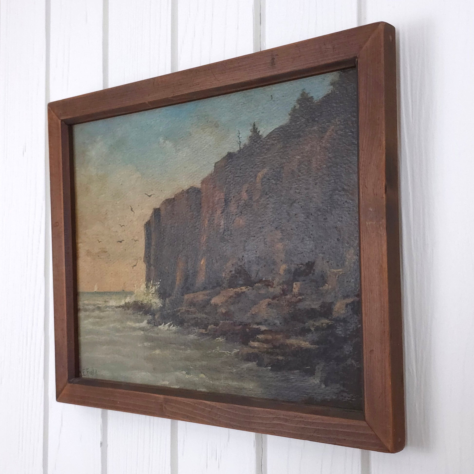 Vintage seaside cliff painting by J.E. Field