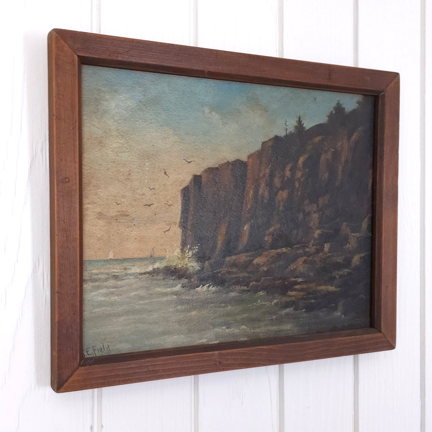 Vintage seaside cliff painting by J.E. Field