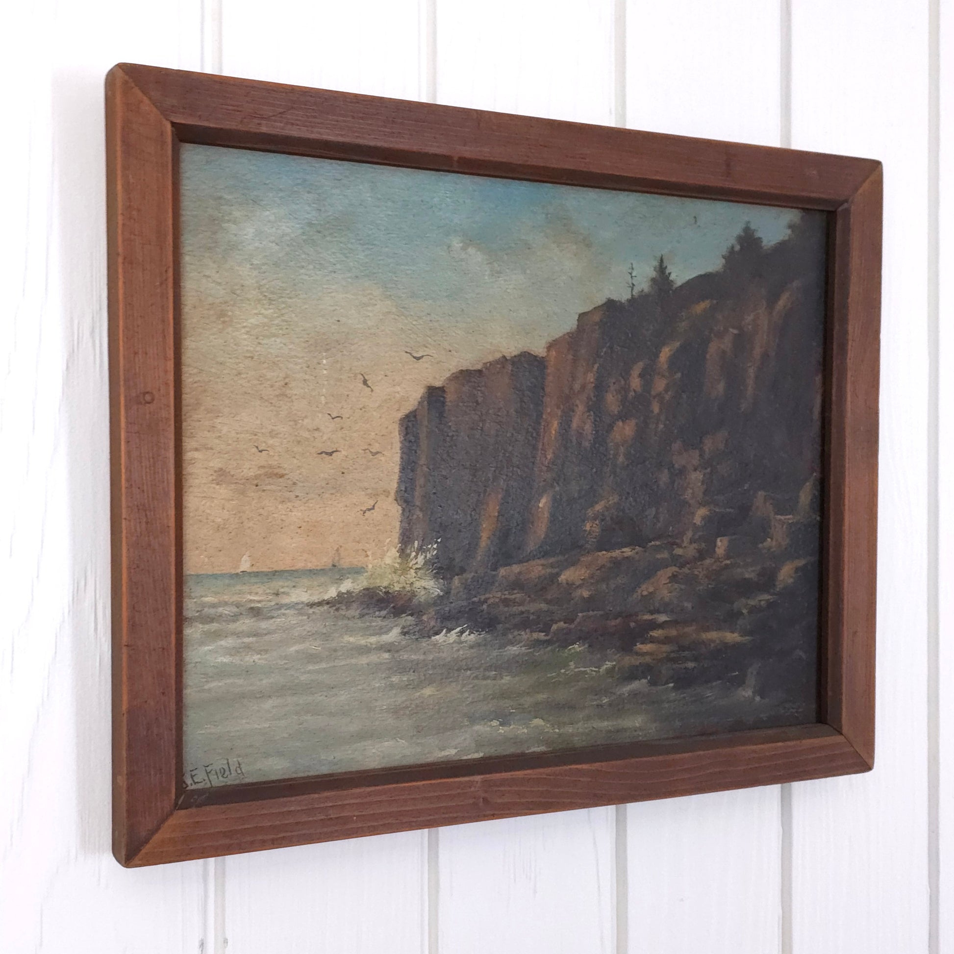 Vintage seaside cliff painting by J.E. Field