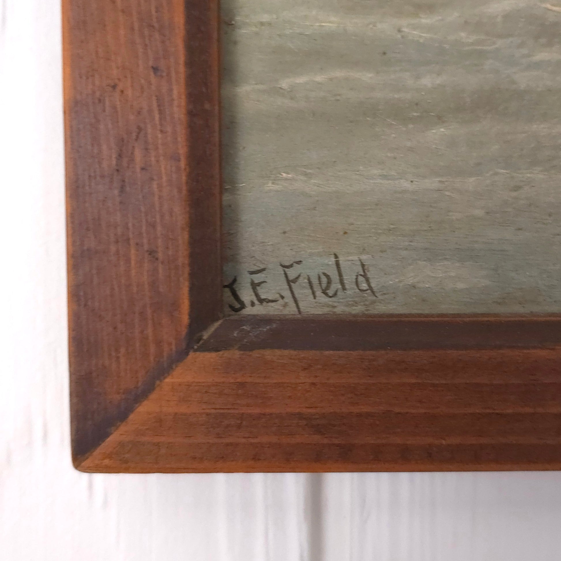 Signature of vintage seaside cliff painting by J.E. Field